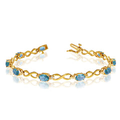 10K Yellow Gold Oval Blue Topaz Stones And Diamonds Infinity Tennis Bracelet, 7" - JewelryAffairs